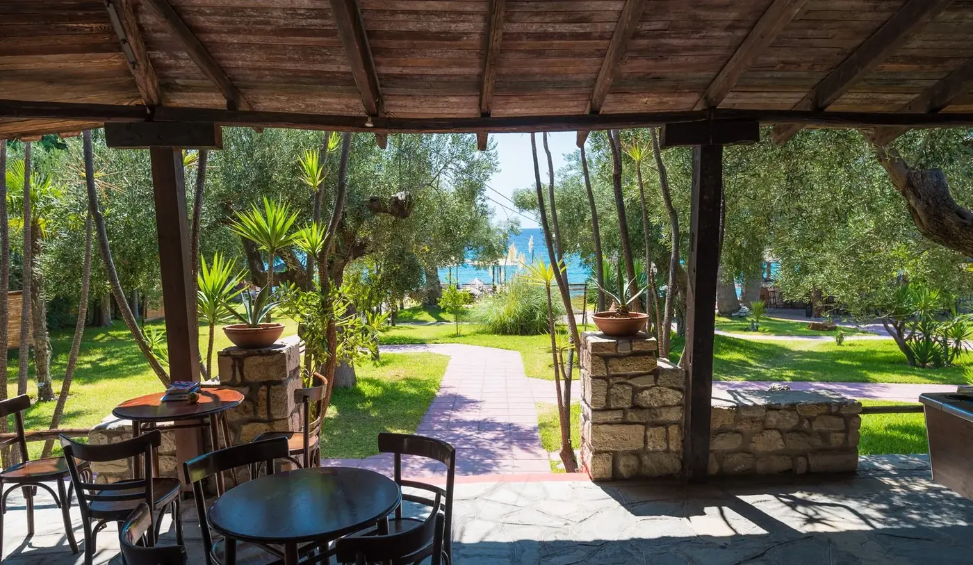 A quiet table shaded by tropical plants in Kudu's garden
