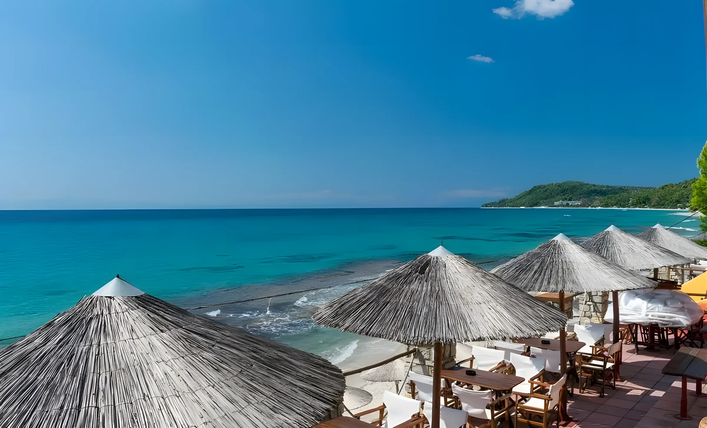 Kudu Beach Bar seen from the sea — umbrellas, stone terraces and gardens above the beach
